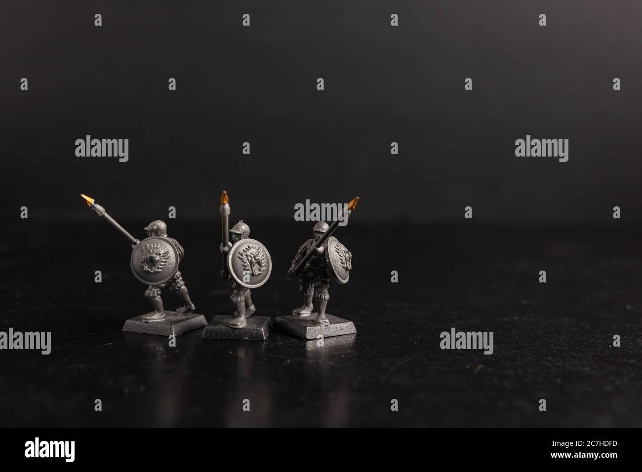 Grayscale selective focus shot of soldier holding spears figurines Stock Photo