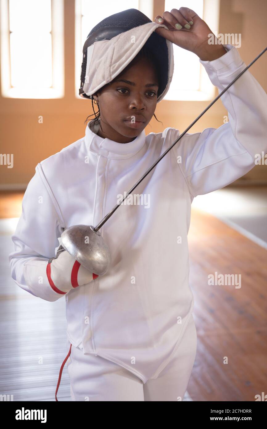 Female fencer removing fencing mask Stock Photo