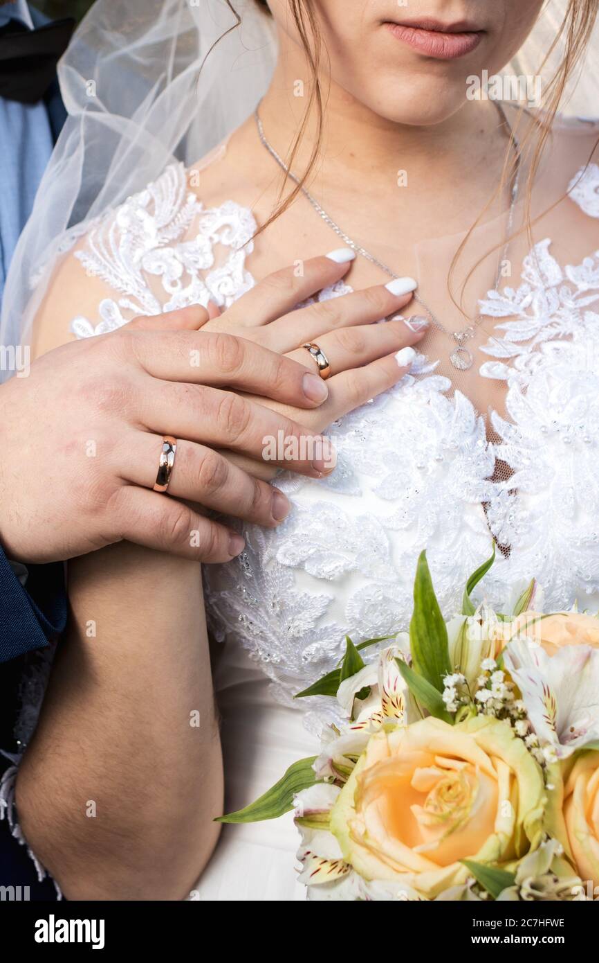 Gold rings in the hands of the bride and groom on the wedding day. Wedding and love Stock Photo