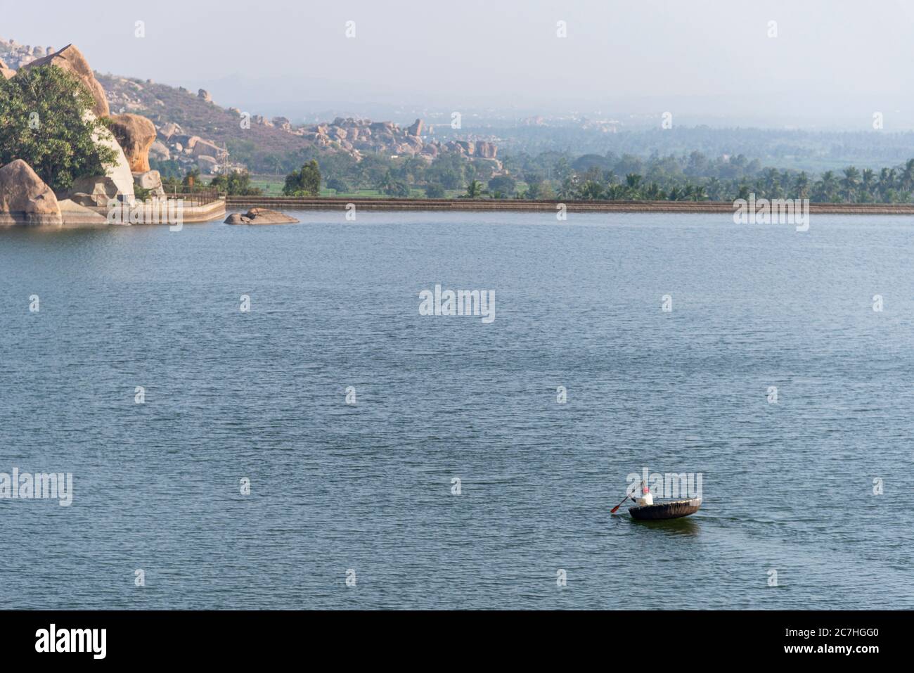 Reservoir with rocky palm trees in the background Stock Photo