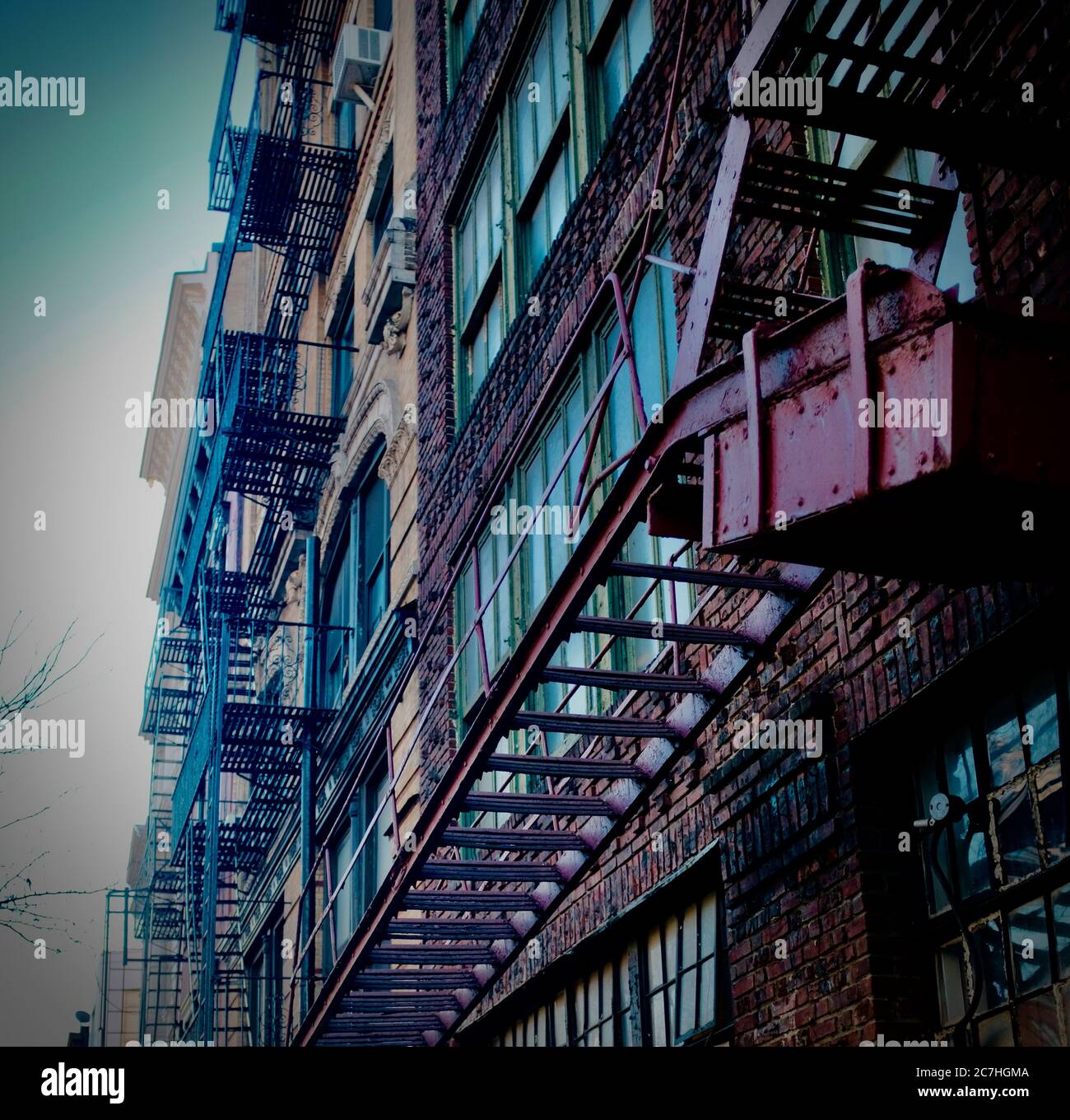 Low angle shot of fire escape stairs on the side of the building Stock