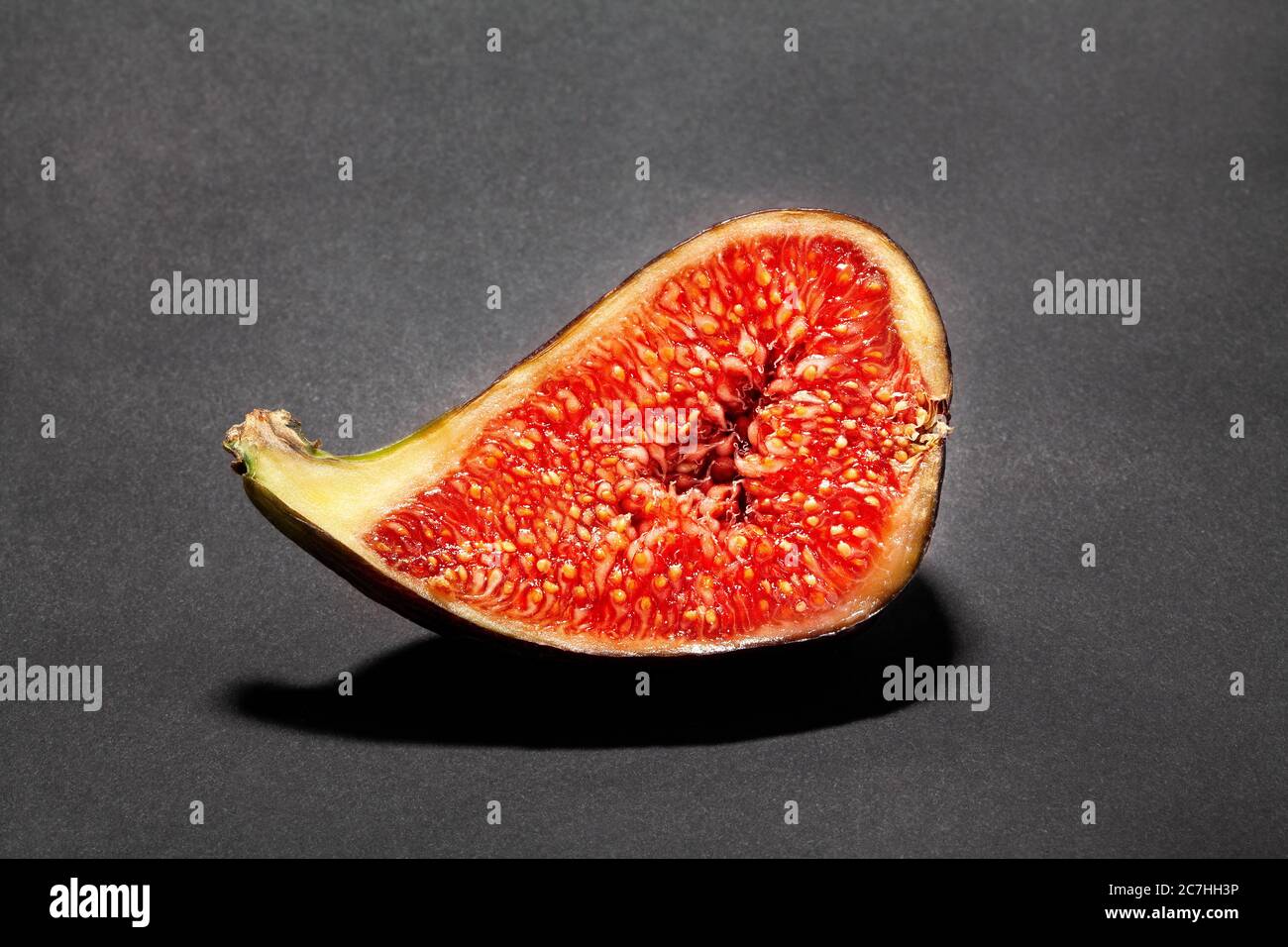 sliced figs on black background Stock Photo