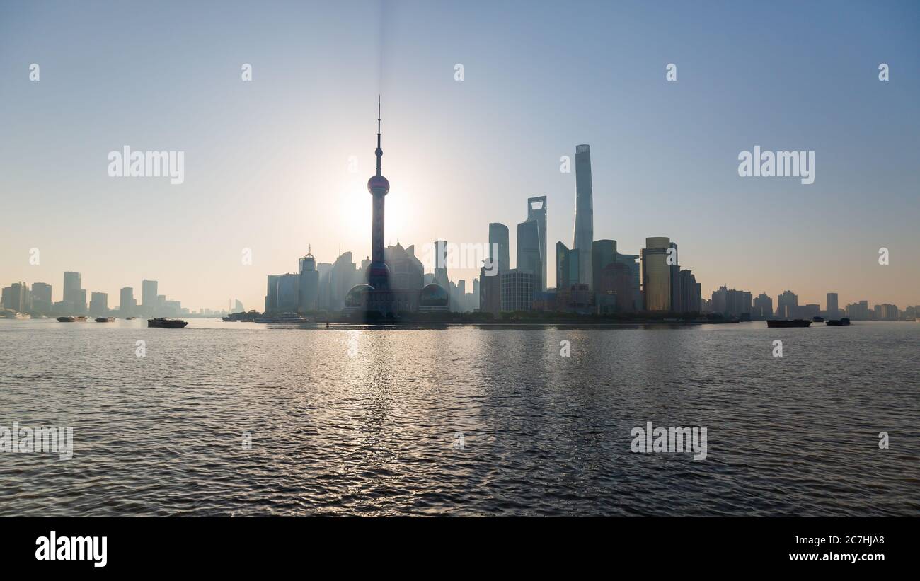 Sun rising behind the Oriental Pearl Tower. Pudong skyline at dusk. Stock Photo