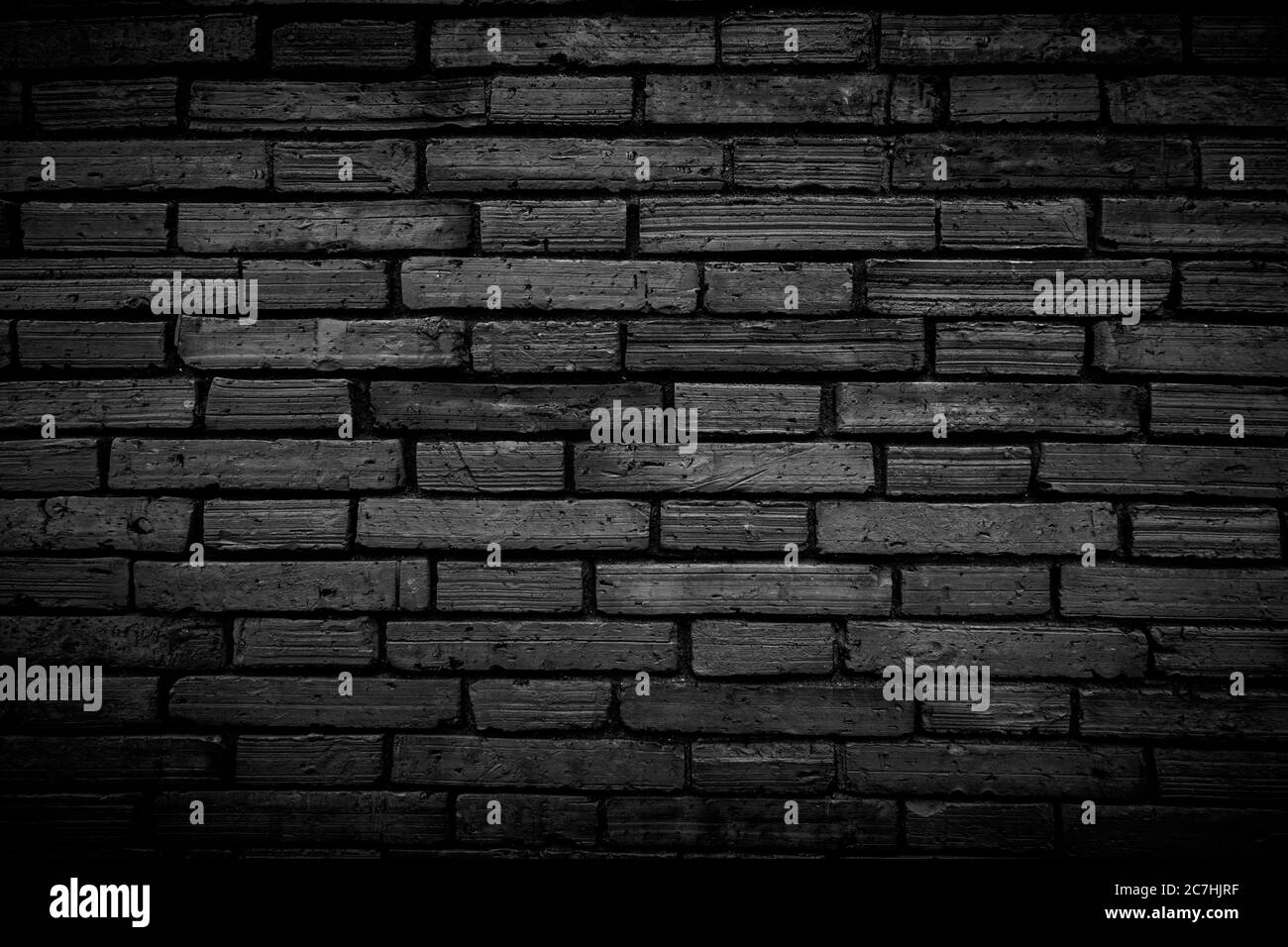 Black brick walls that are not plastered background and texture. The