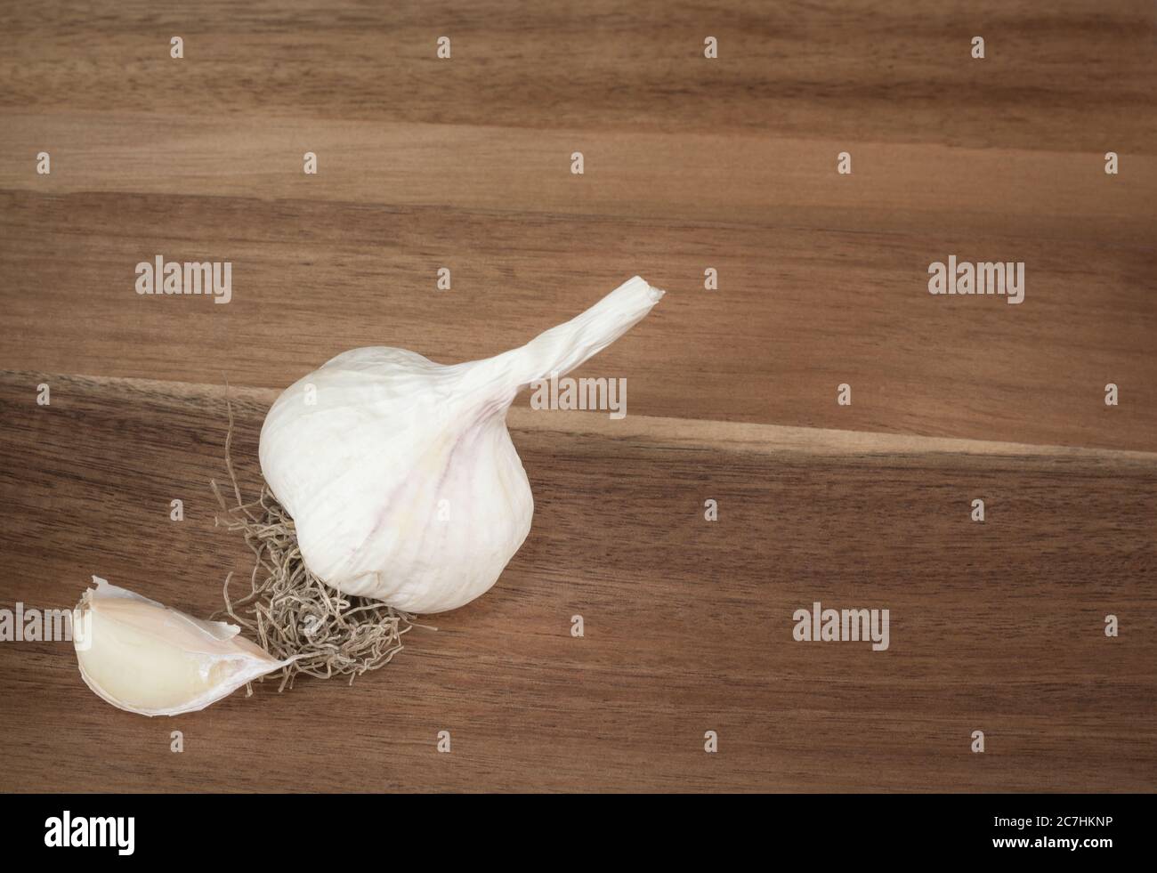 Garlic and clove of garlic on a board Stock Photo - Alamy