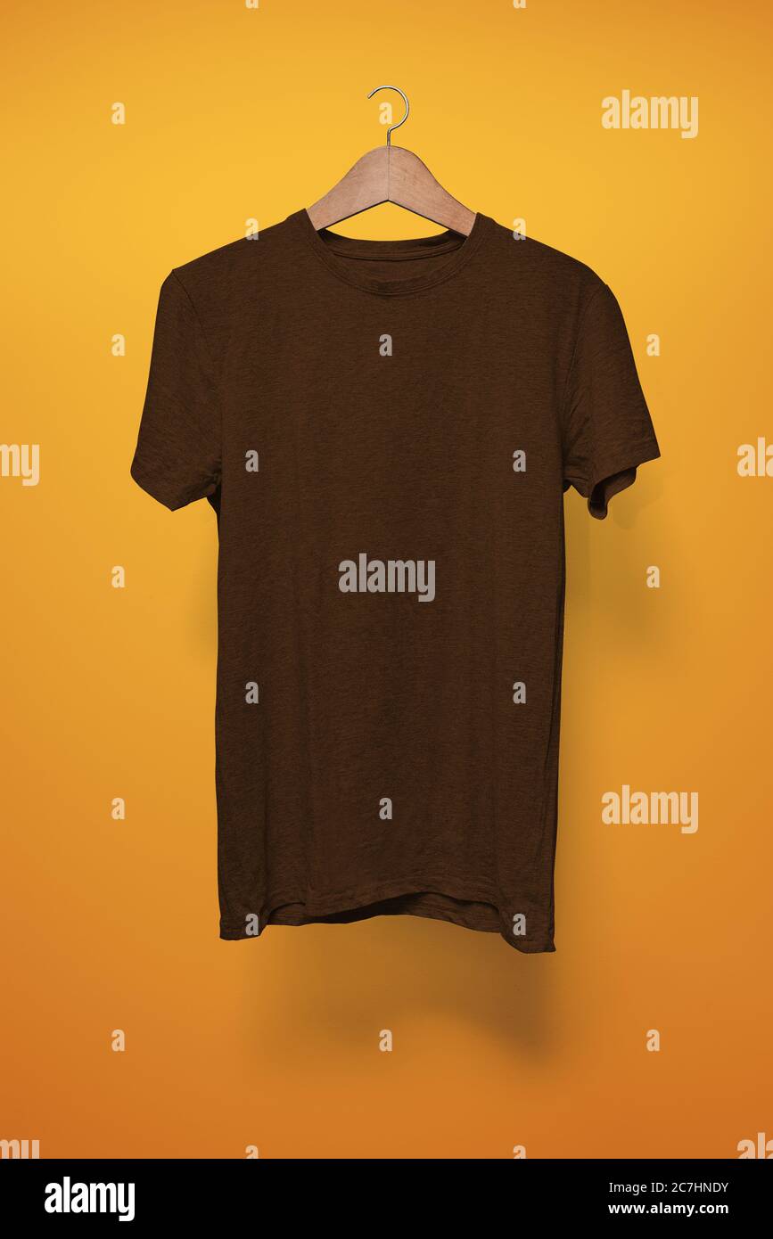 Download Brown T Shirt On A Hanger Against An Orange Background Stock Photo Alamy