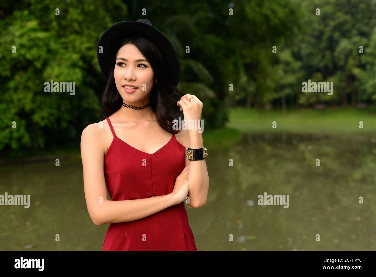 Portrait of young beautiful Asian woman at the park Stock Photo - Alamy