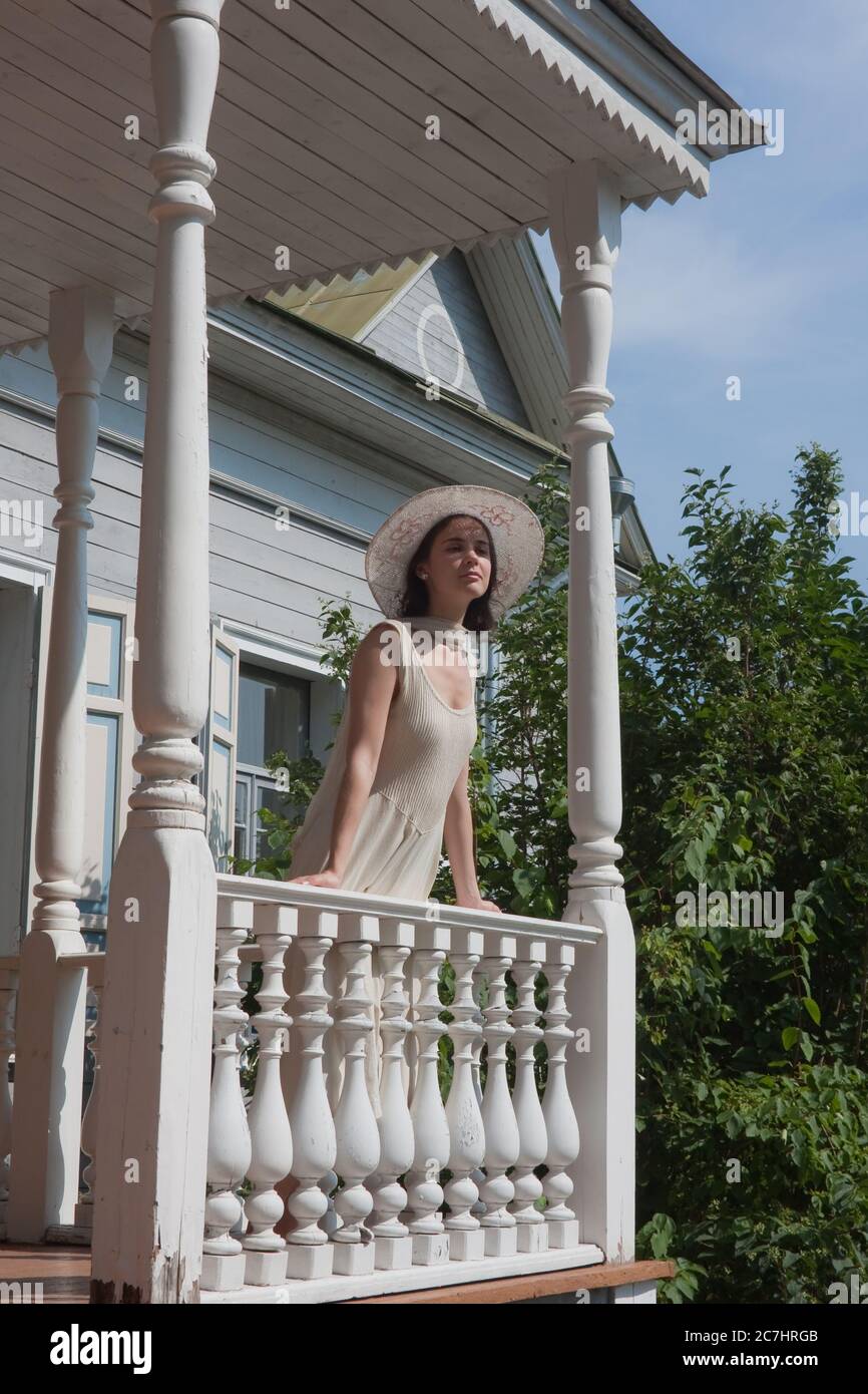 The girl on the porch of the old manor Stock Photo - Alamy