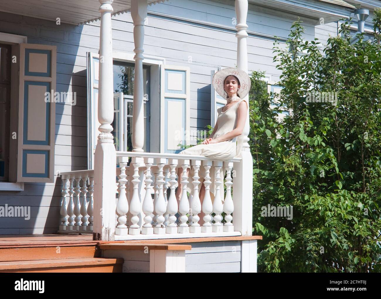 The girl on the porch of the old manor Stock Photo - Alamy