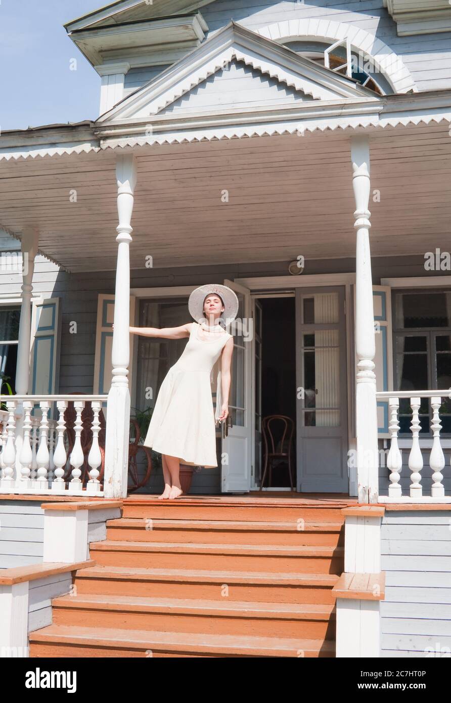The girl on the porch of the old manor Stock Photo - Alamy