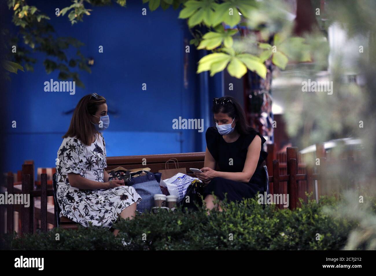 Ankara, Turkey. 17th July, 2020. Women wearing face masks sit on a bench in Ankara, Turkey, on July 17, 2020. Turkish Health Minister Fahrettin Koca on Friday warned of the increasing number of intensive care and intubated COVID-19 patients in the country. Turkey's daily coronavirus cases increased by 926 on Friday, raising the overall number to 217,799, the minister said. Credit: Mustafa Kaya/Xinhua/Alamy Live News Stock Photo