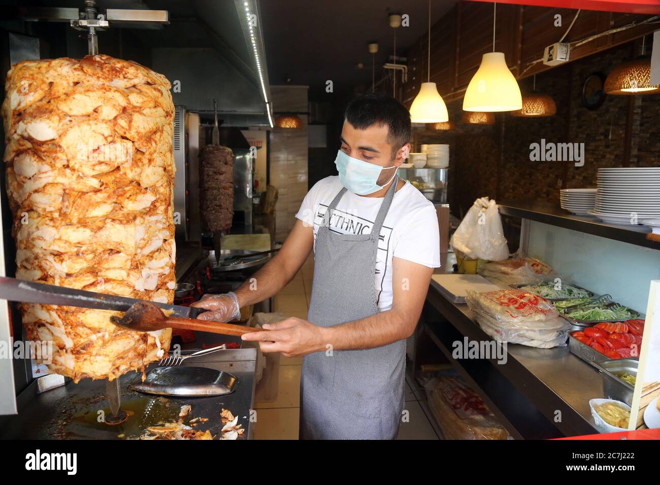 Ankara, Turkey. 17th July, 2020. A chef wearing a face mask prepares meal at a restaurant in Ankara, Turkey, on July 17, 2020. Turkish Health Minister Fahrettin Koca on Friday warned of the increasing number of intensive care and intubated COVID-19 patients in the country. Turkey's daily coronavirus cases increased by 926 on Friday, raising the overall number to 217,799, the minister said. Credit: Mustafa Kaya/Xinhua/Alamy Live News Stock Photo