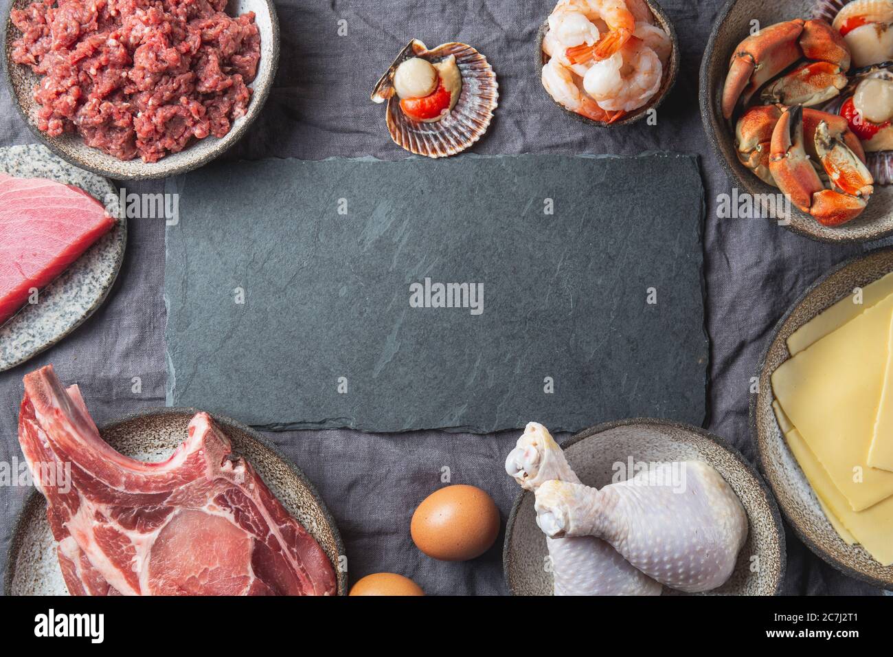Animal protein sources background with copy space. Carnivore diet concept. Meat, cheese, fish, eggs and seafood Stock Photo
