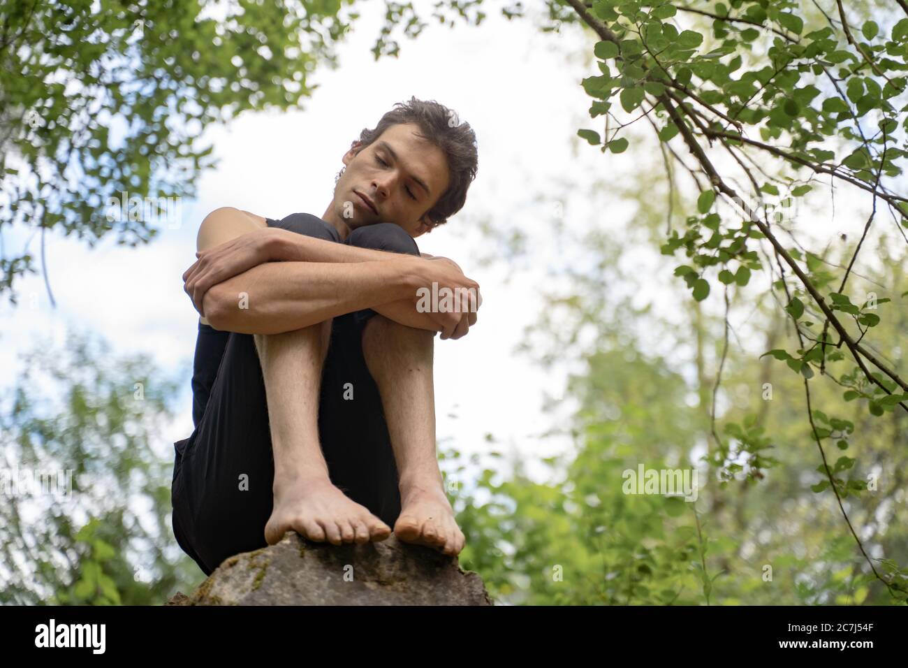 Man sitting on knees hi-res stock photography and images - Alamy