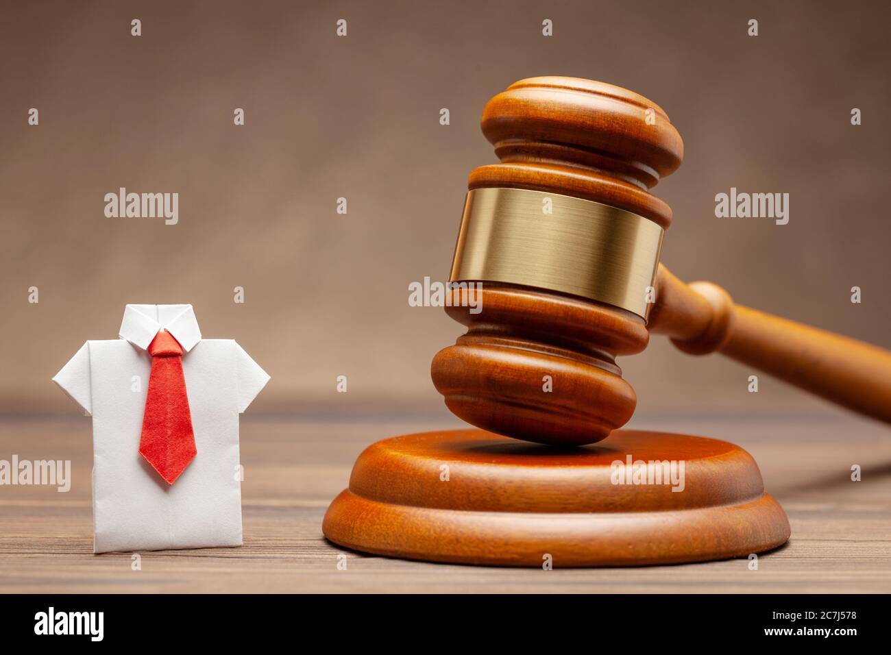 Businessman in shirt and tie and judge gavel on brown background. Concept of business sentence or condemnation of businessman. Stock Photo