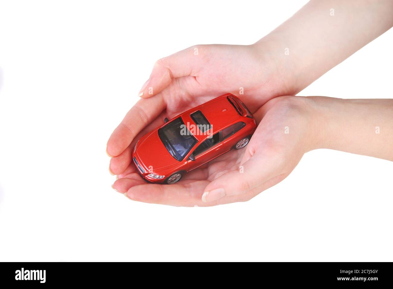 red toy car in female hands Stock Photo