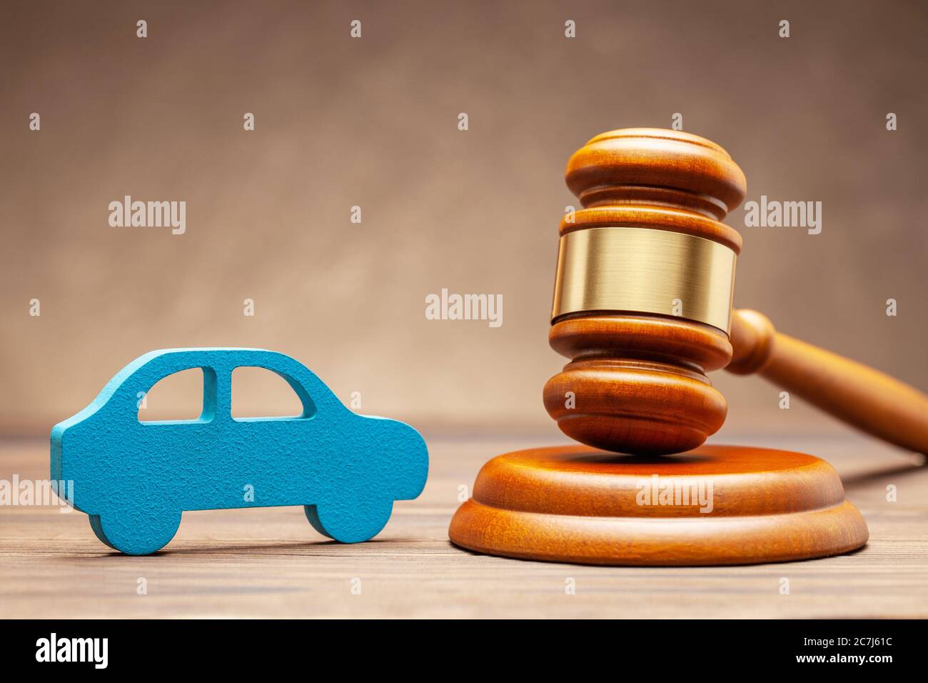 Car and judge gavel on brown background. Concept of selling a car by