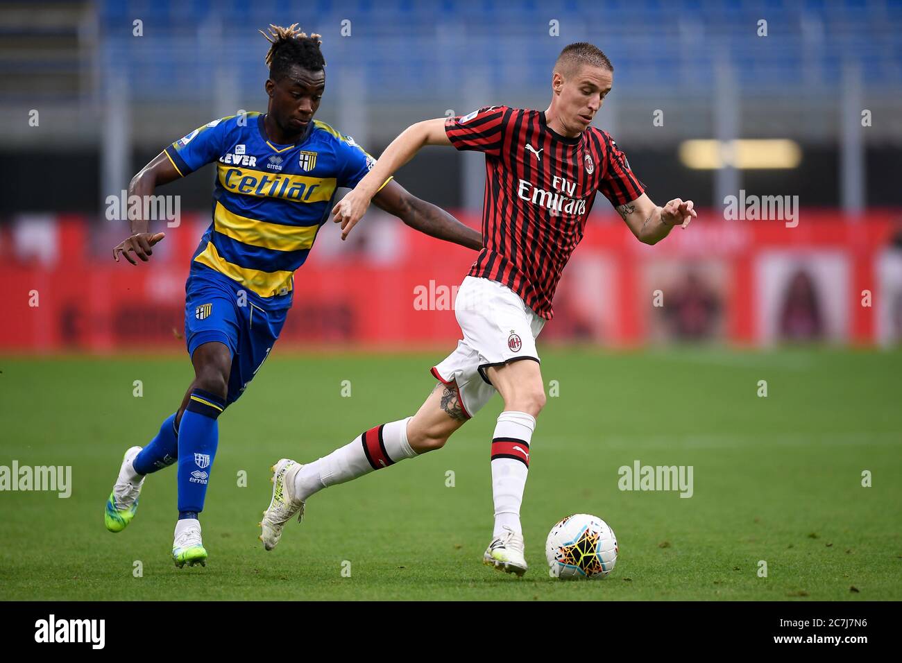 Milan, Italy - 15 July, 2020: Andrea Conti (R) of AC Milan is challenged by  Yann Karamoh of Parma Calcio during the Serie A football match between AC  Milan and Parma Calcio.