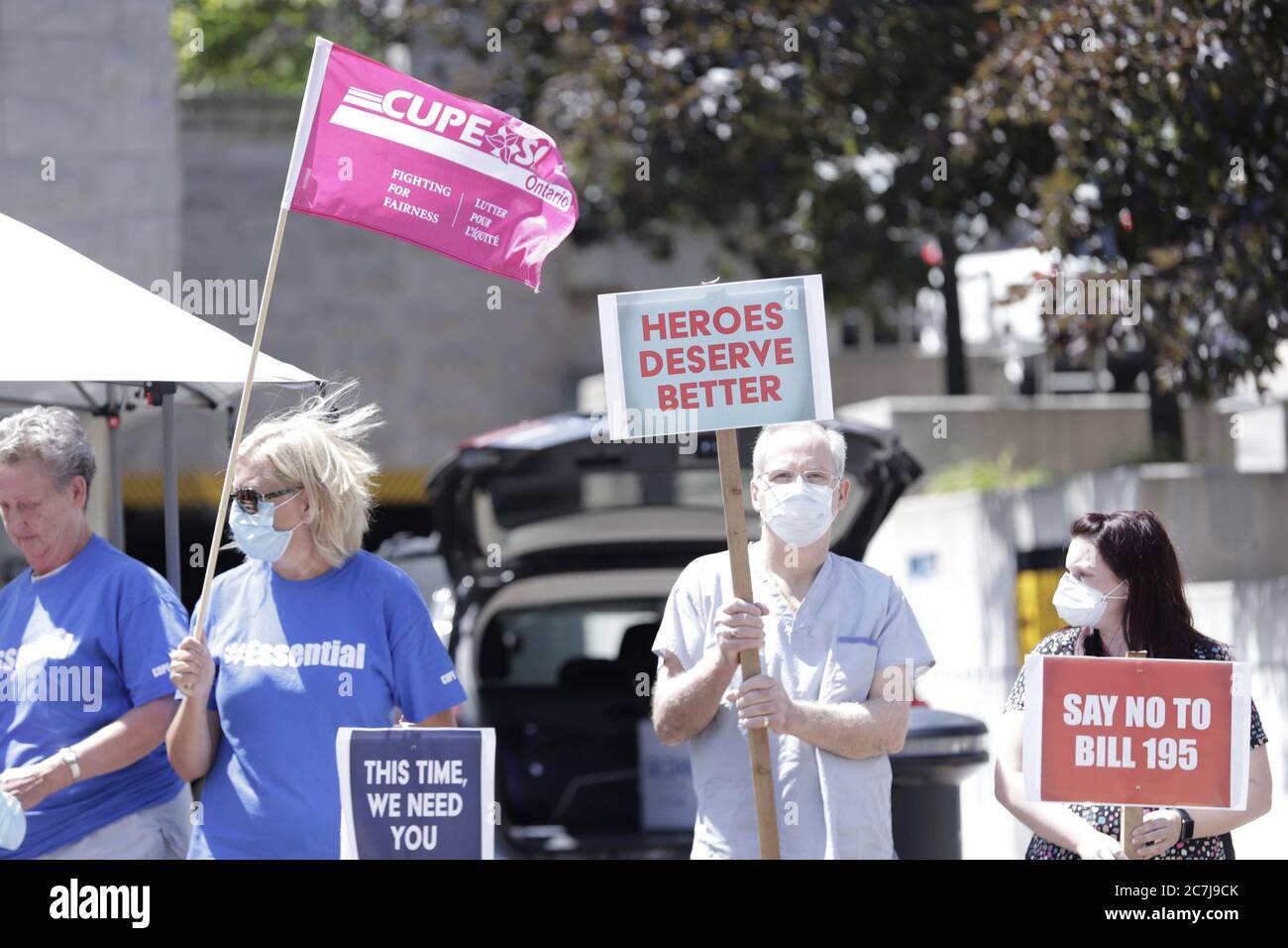 Healthcare workers are seen holding up posters and protesting against Ontario's government  Bill 195 Stock Photo