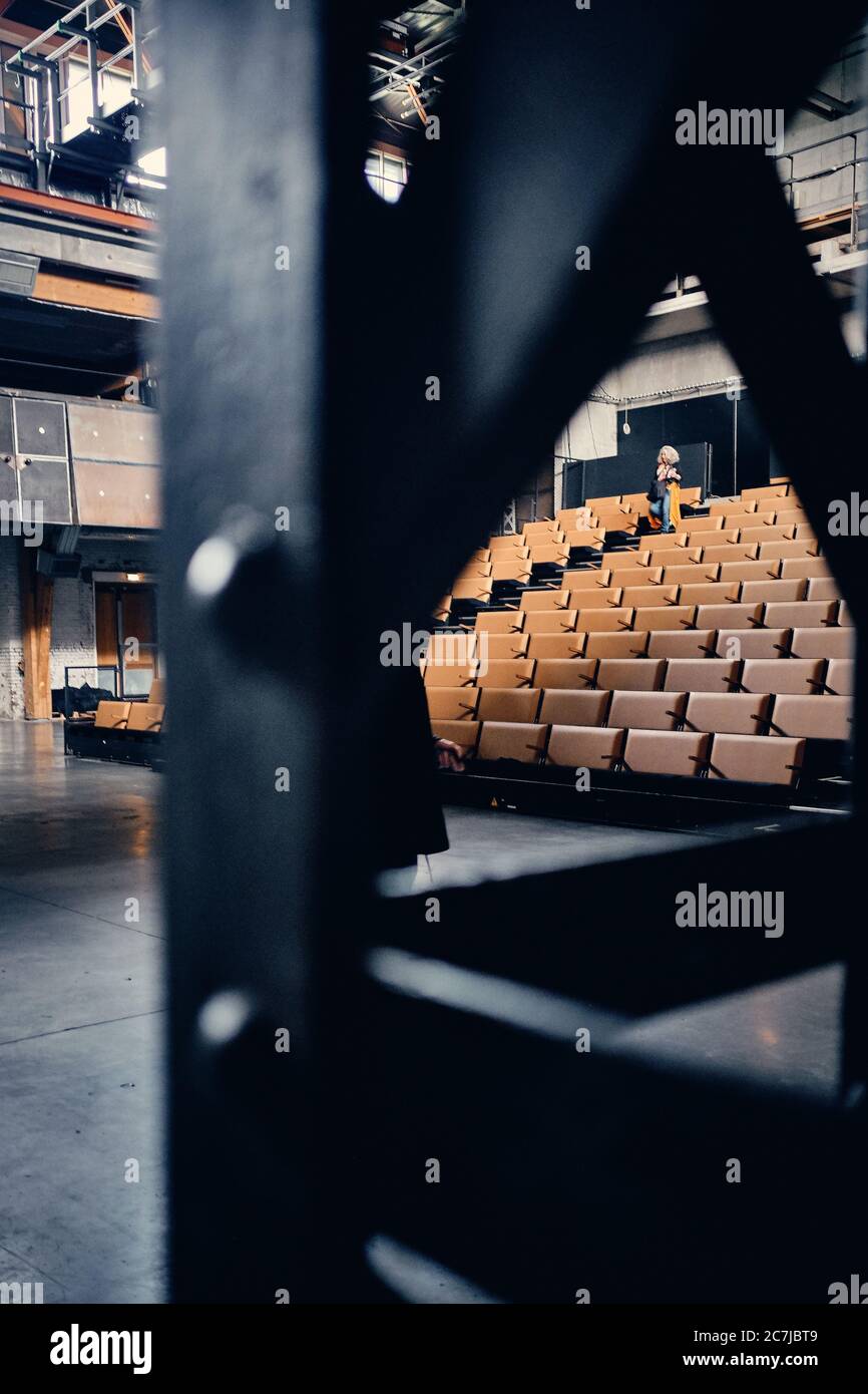Vertical shot of an empty theatre auditorium with a lot of chairs in Roubaix, France Stock Photo