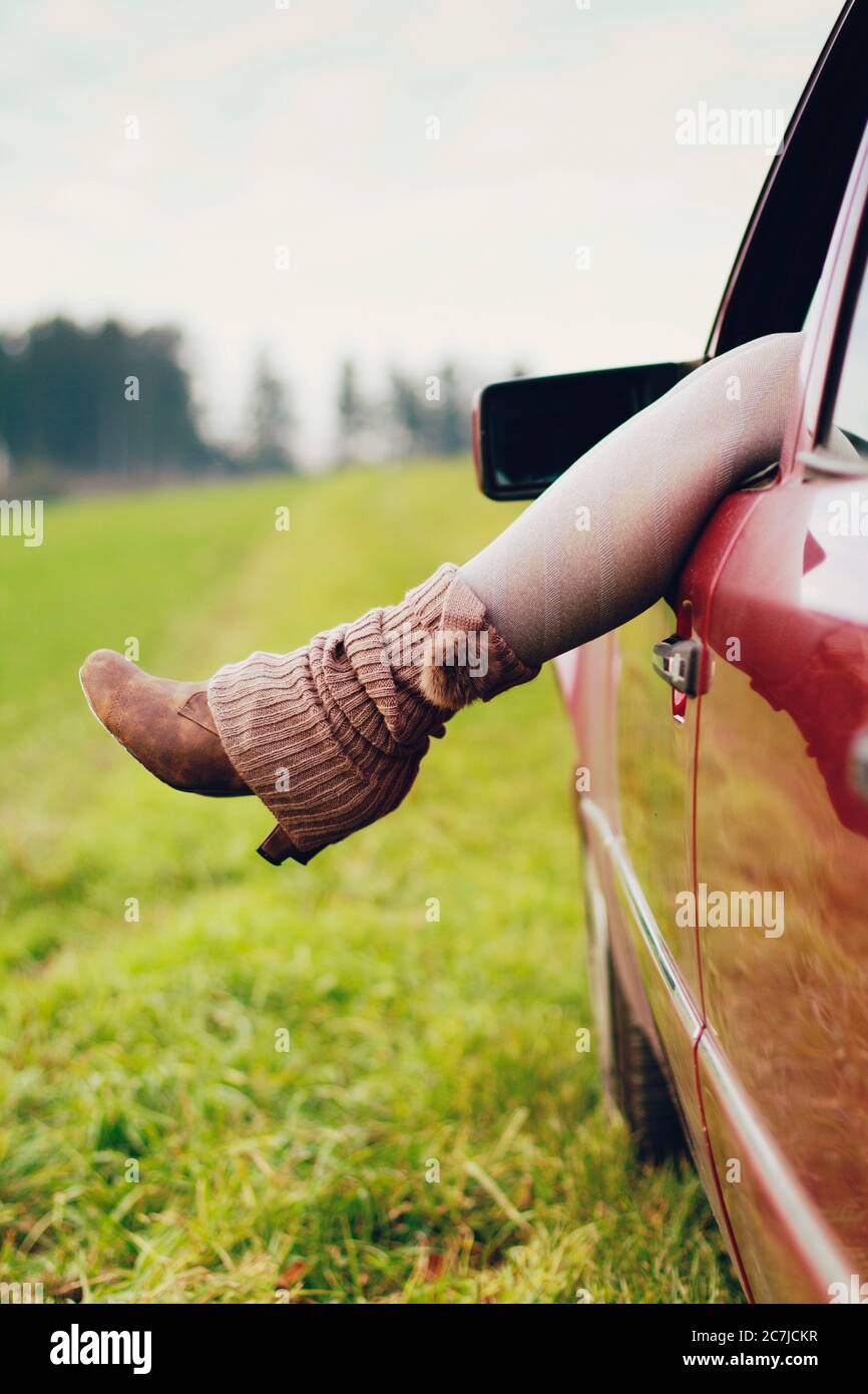 Car window, woman's leg, detail Stock Photo