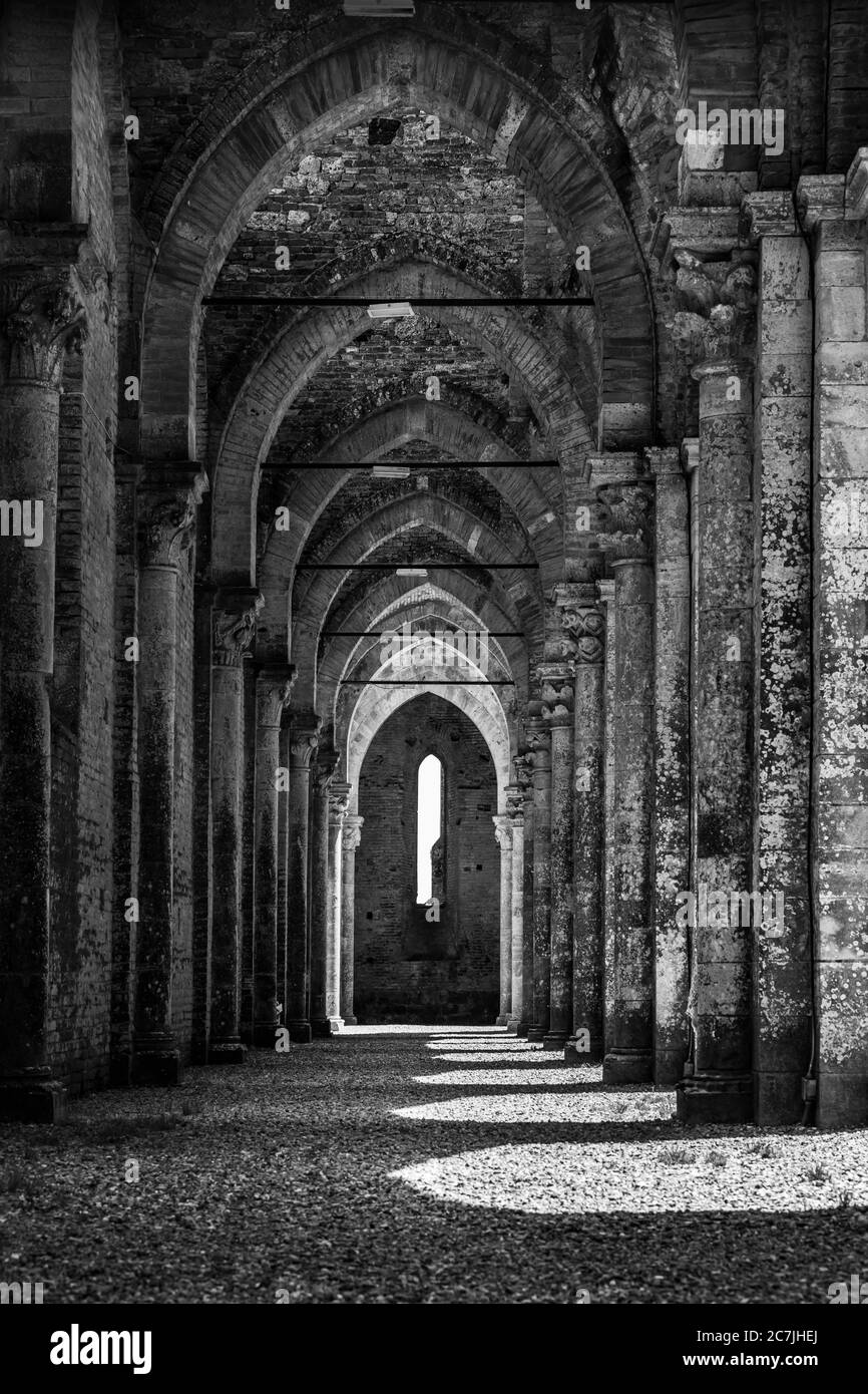 Vertical greyscale shot of famous historic Abbey of Saint Galgano in Tuscany, Italy Stock Photo