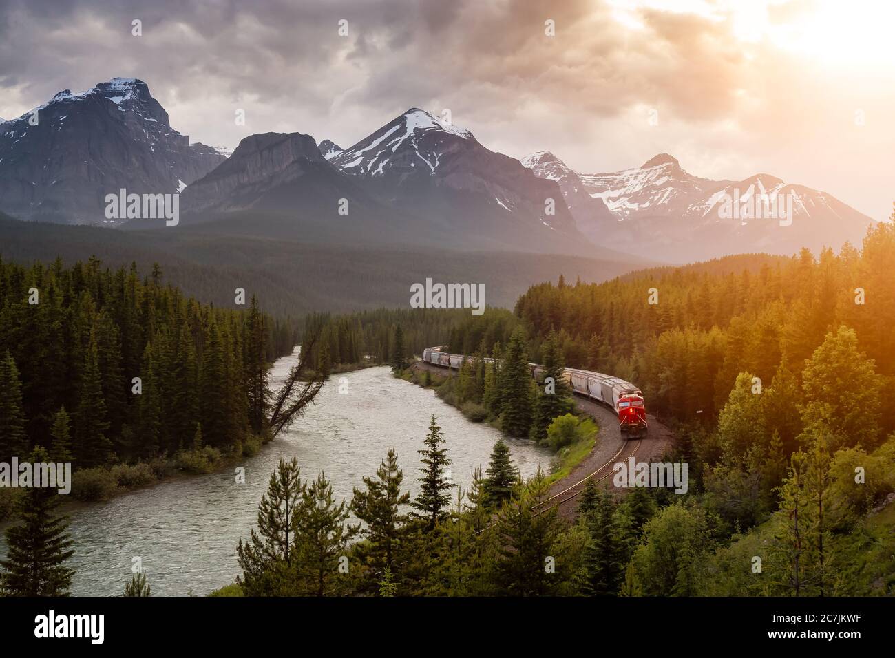 Iconic View of Morant's Curve with Train Passing and Canadian Rocky Mountain Landscape Stock Photo