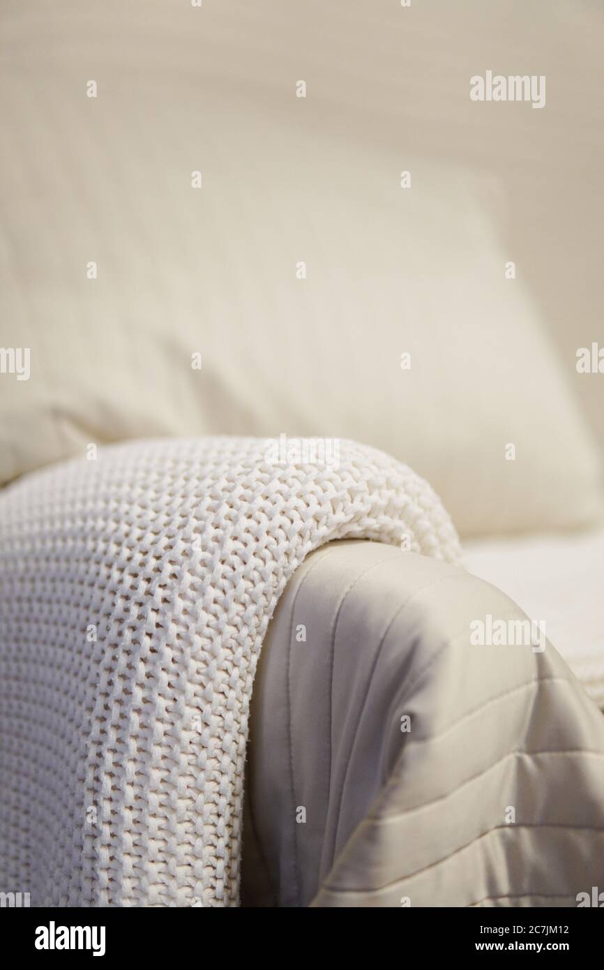 White cozy blanket on a sofa with a blurred background Stock Photo Alamy