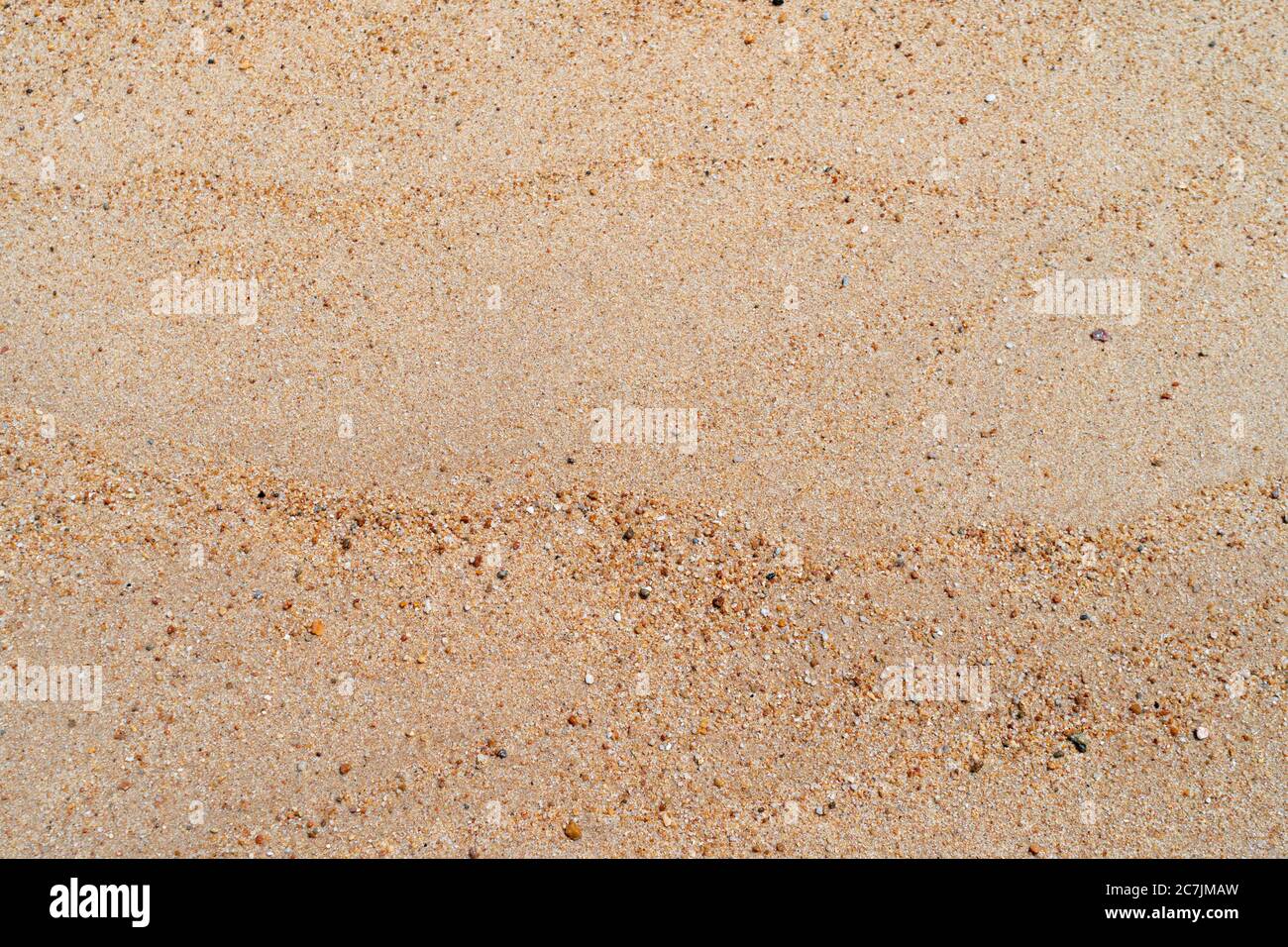 Brown sand texture background from fine sand with natural line wave on it. Stock Photo