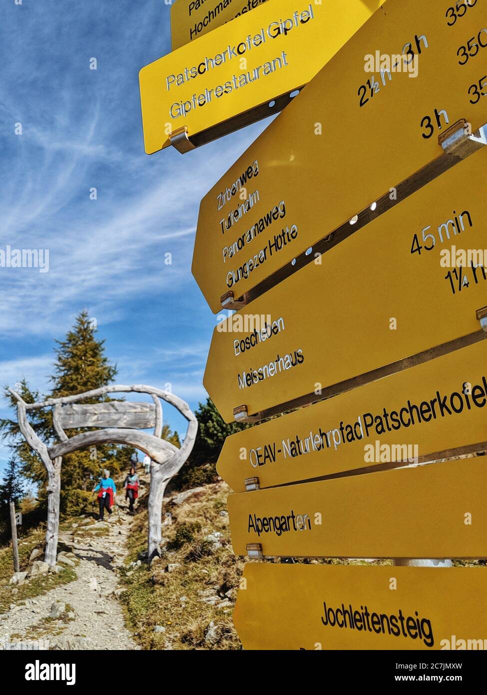 Hiking signpost, in the background the starting point of the Zirbenweg on the Patscherkofel Stock Photo