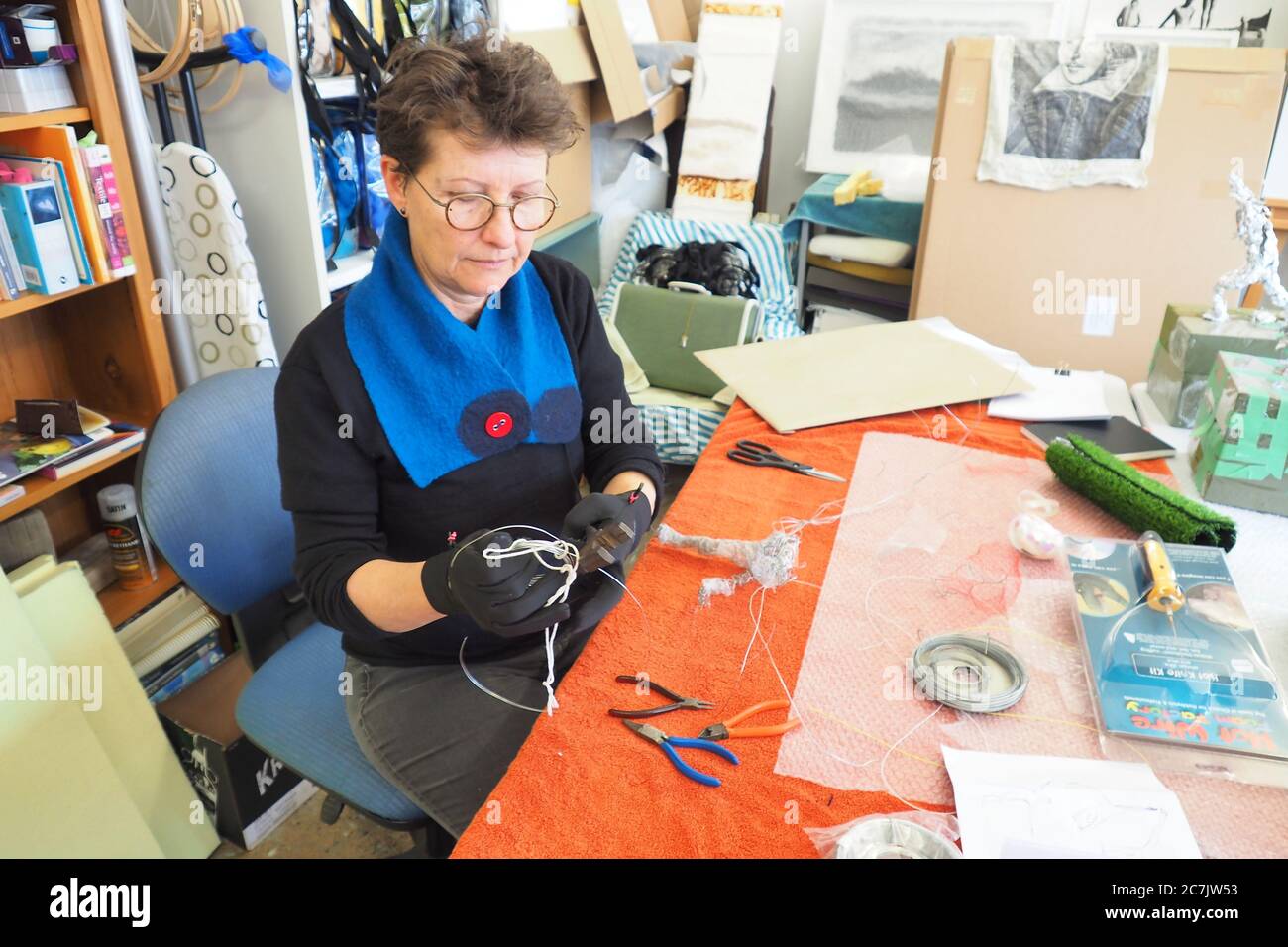 A mixed media artist works with wire in her studio at Toi Poneke in Wellington NZ Stock Photo