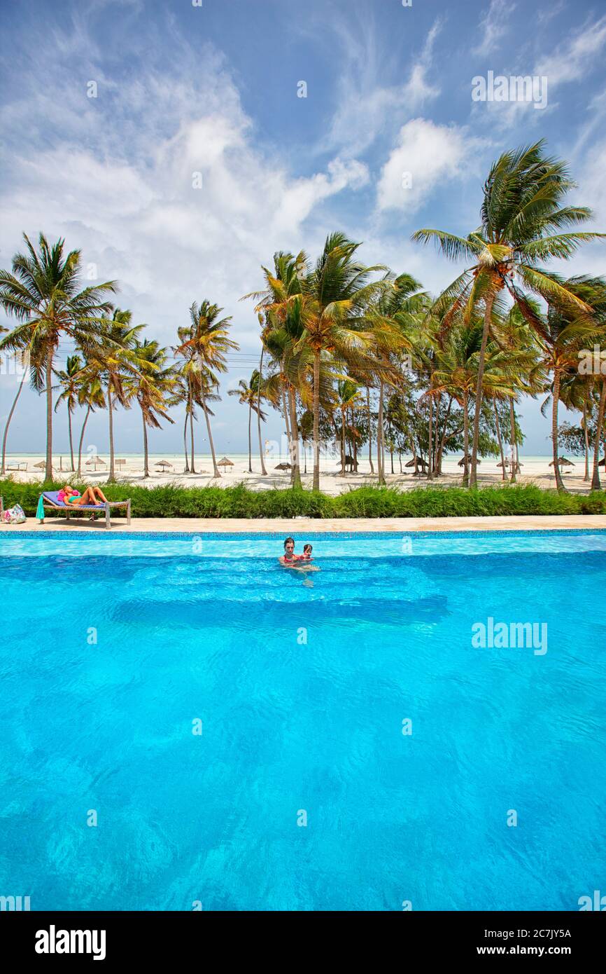 Mother and daughter swimming in a pool near the beach in Paje, Zanzibar, Stock Photo