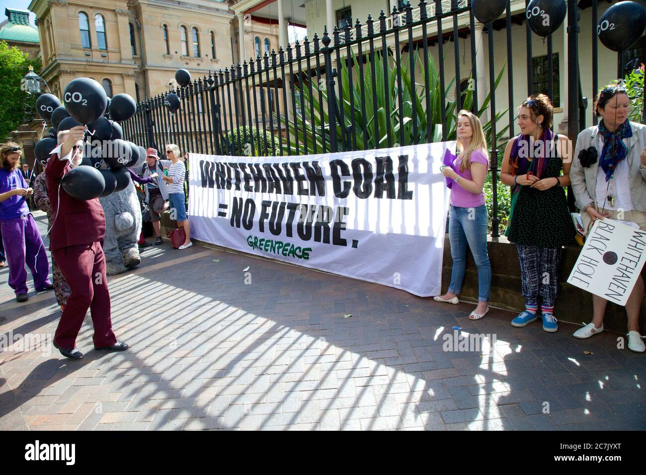 A Greenpeace banner saying, ‘Whitehaven Coal = No Future’ appears outside the location of the Whitehaven Coal AGM and people hold black balloons with Stock Photo