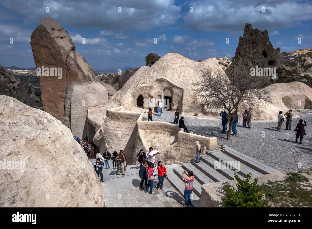 Visitors to the Open Air Museum near Goreme in the Cappadocia region of Turkey file out of the Chapel of St Basil containing the fresco of Jesus. Stock Photo