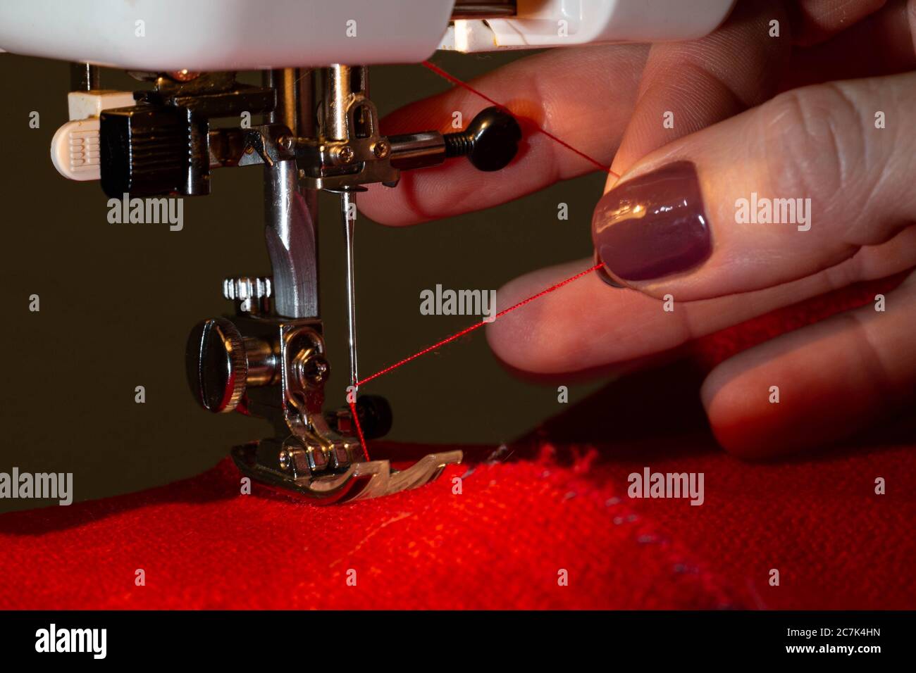 Sewing on sewing machine with beautiful female hands Stock Photo