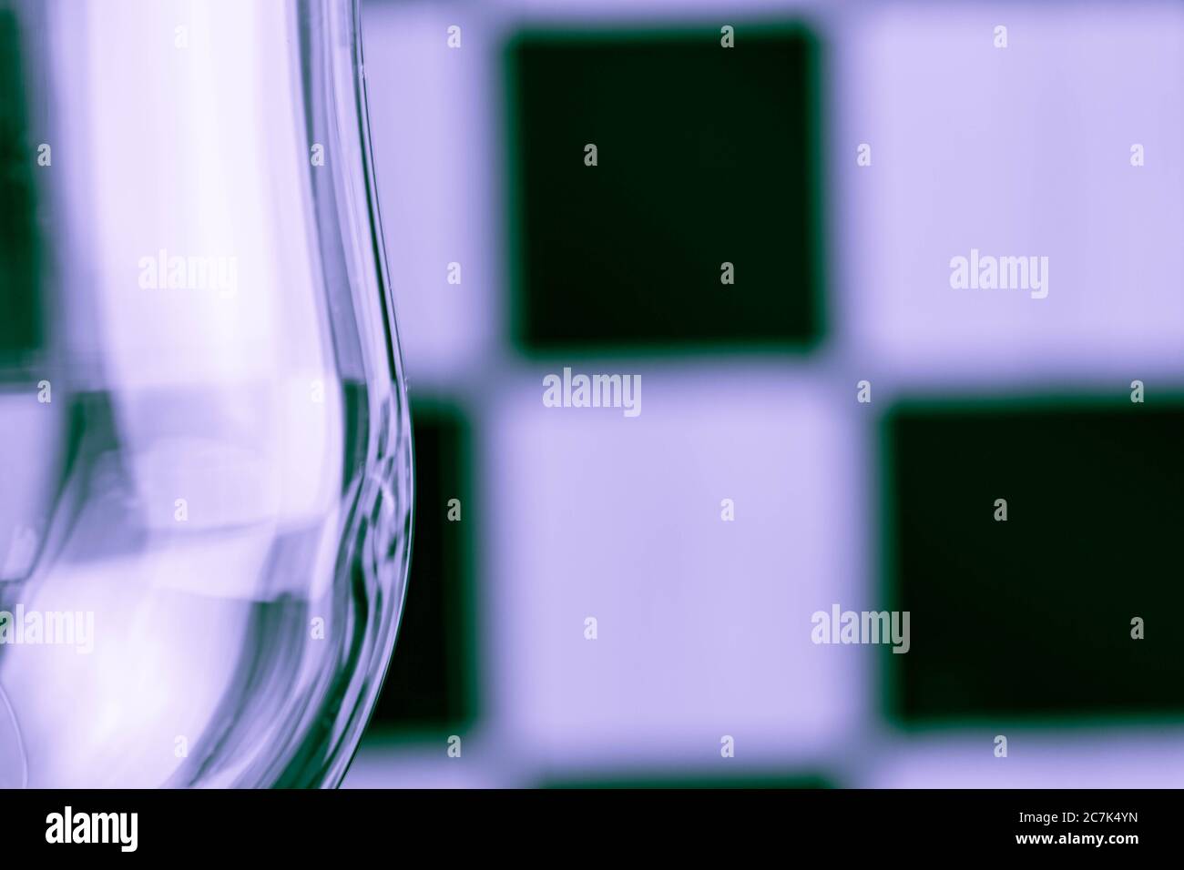 Part of glass amid black and white squares Stock Photo