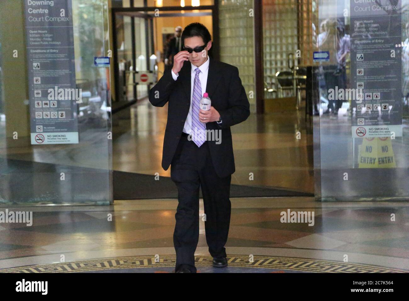 Police officer Chin Aun Lim leaves Downing Centre Court in Sydney. Stock Photo
