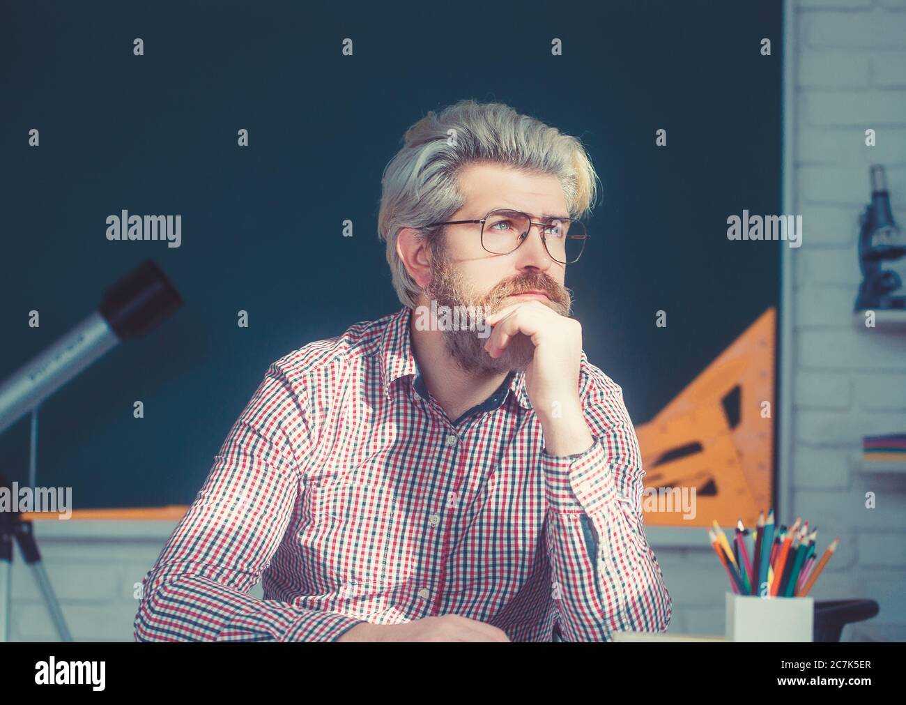 Grey hair professor thinking and looking in window. Stock Photo