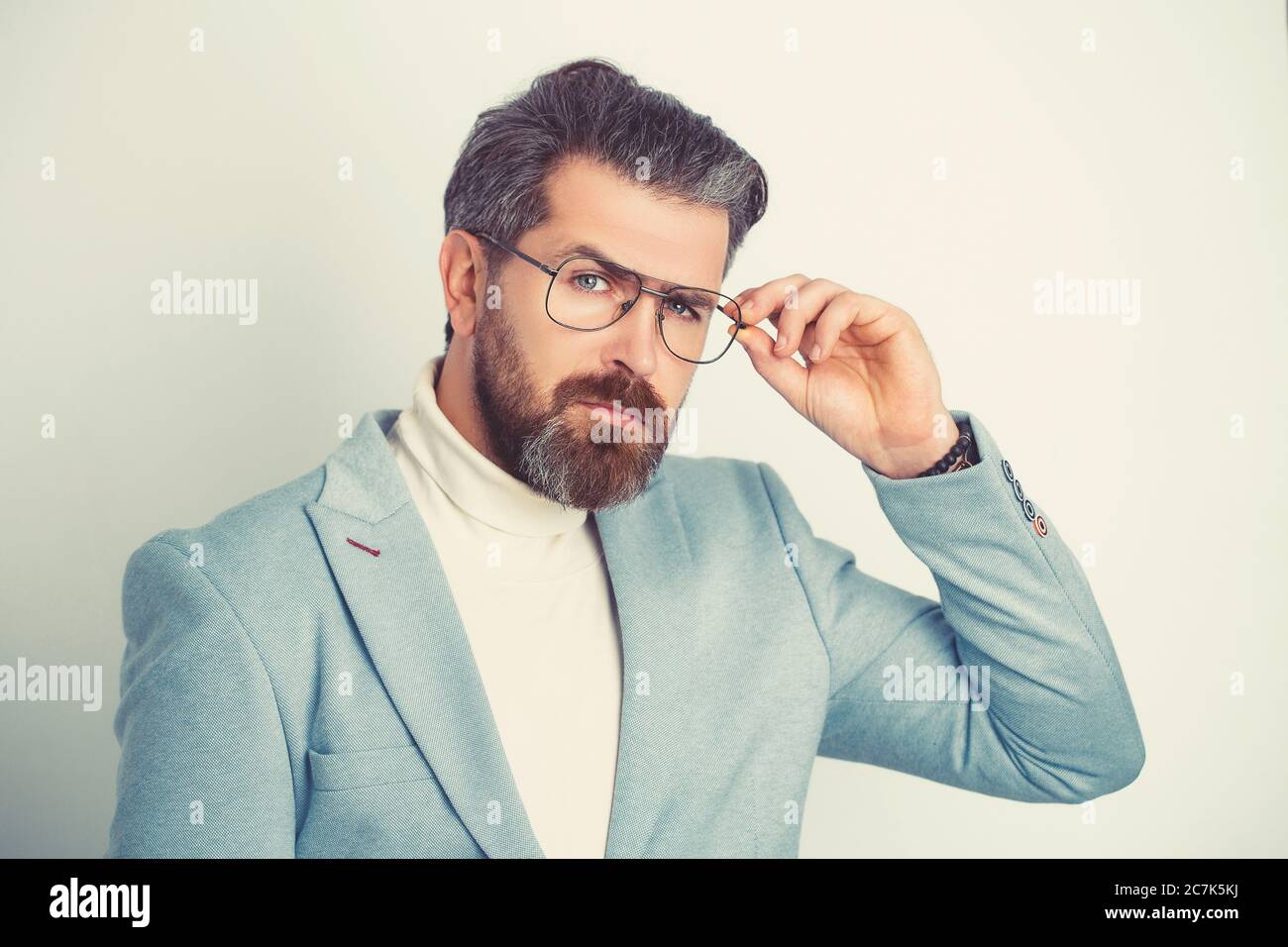 Attractive young man wearing suit with glasses. Stock Photo