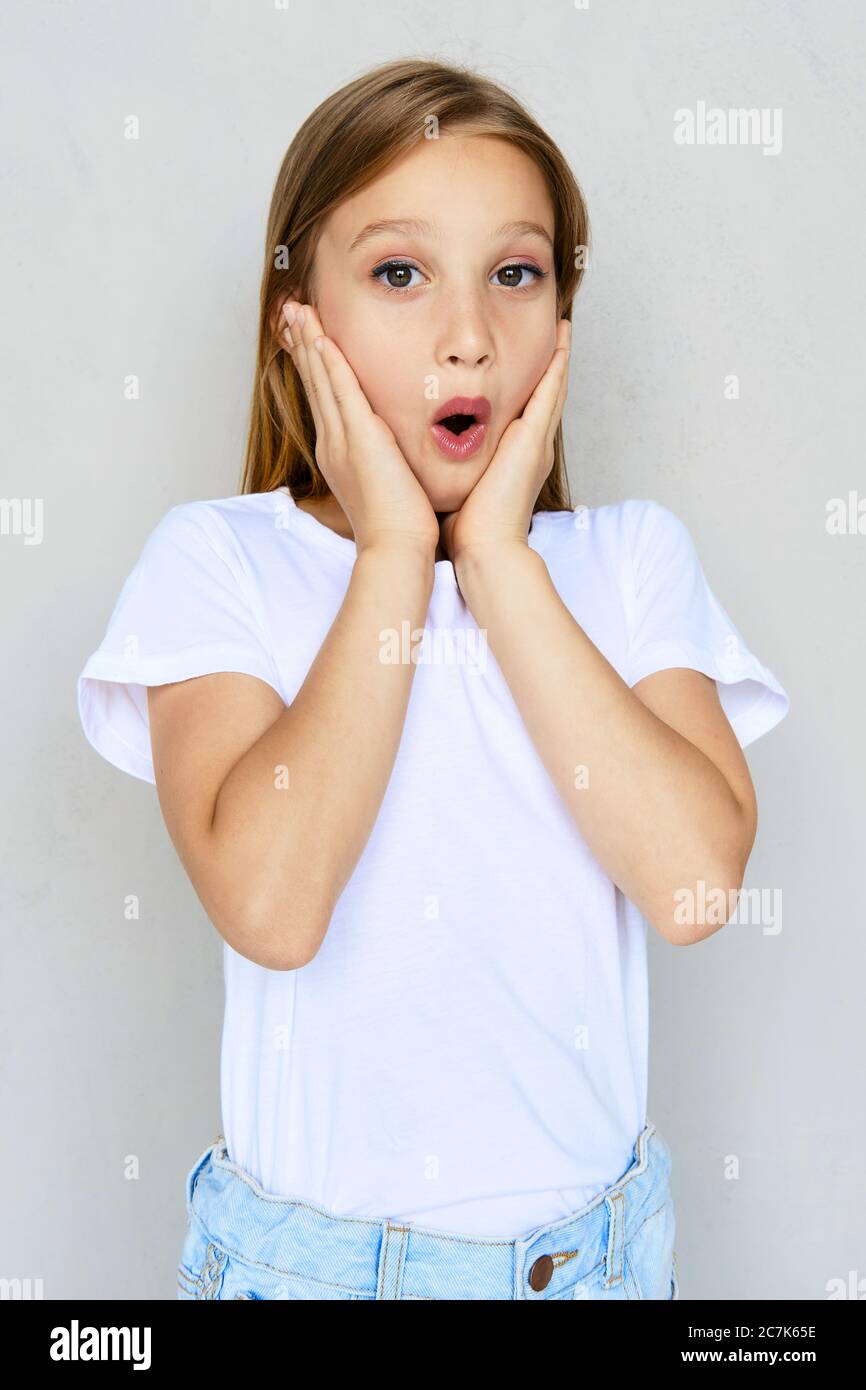 Young surprised girl with hands on cheeks Stock Photo - Alamy