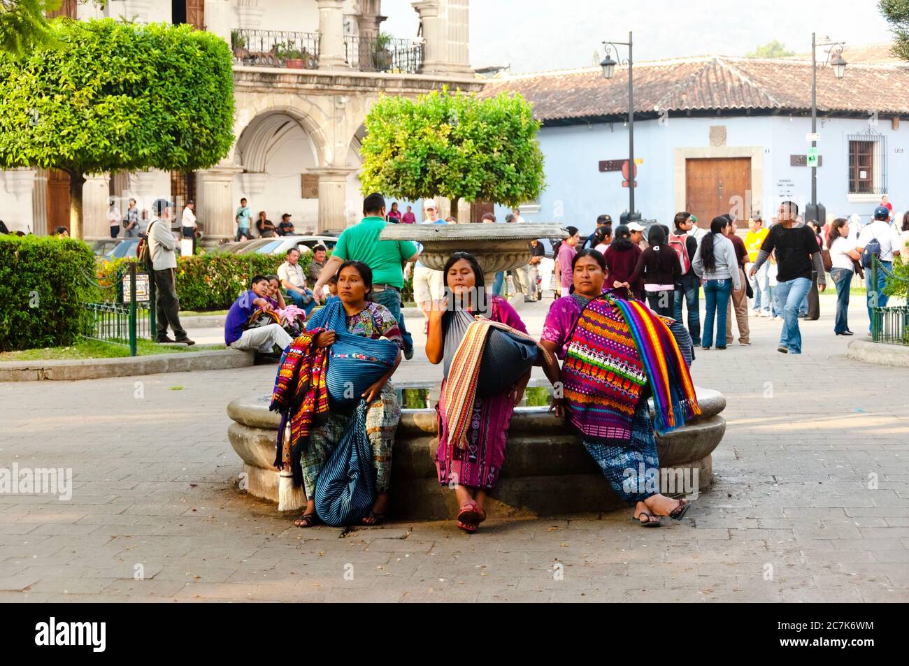 Antigua, Guatemala - May 02, 2011: Three traditionally dressed women in the main town plaza. Stock Photo