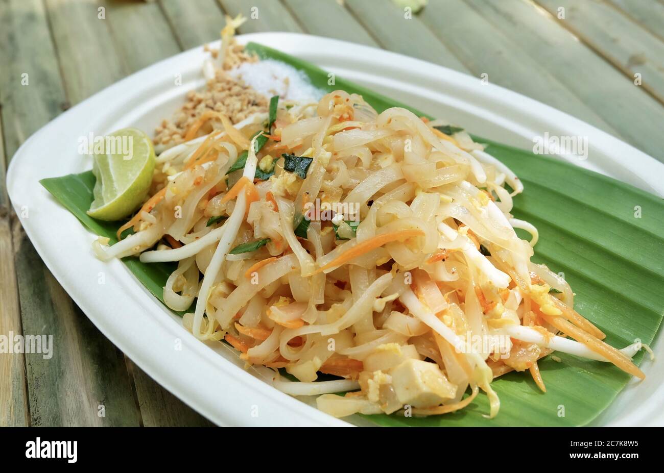 Thai Cuisine, Pad Thai or Thai Stir Fried Noodles and Dried Shrimps Served with Roasted Ground Peanuts, Lime and Sugar. One of The Most Popular Dish i Stock Photo