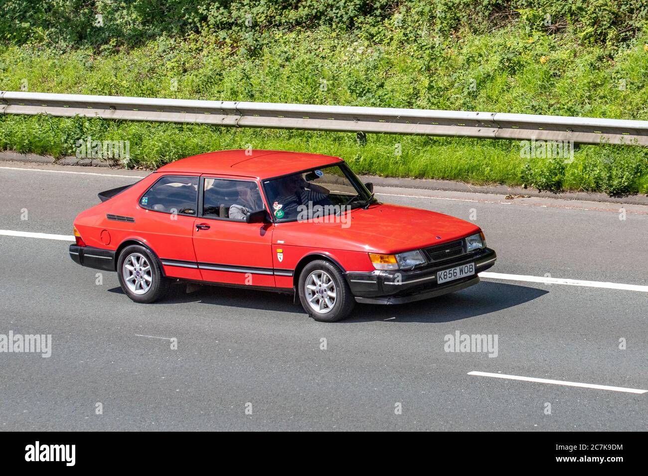K856WOB 1992 red Saab 900 S Turbo; Vehicular traffic moving vehicles, cars driving vehicle on UK roads, motors, motoring on the M6 motorway highway network. Stock Photo