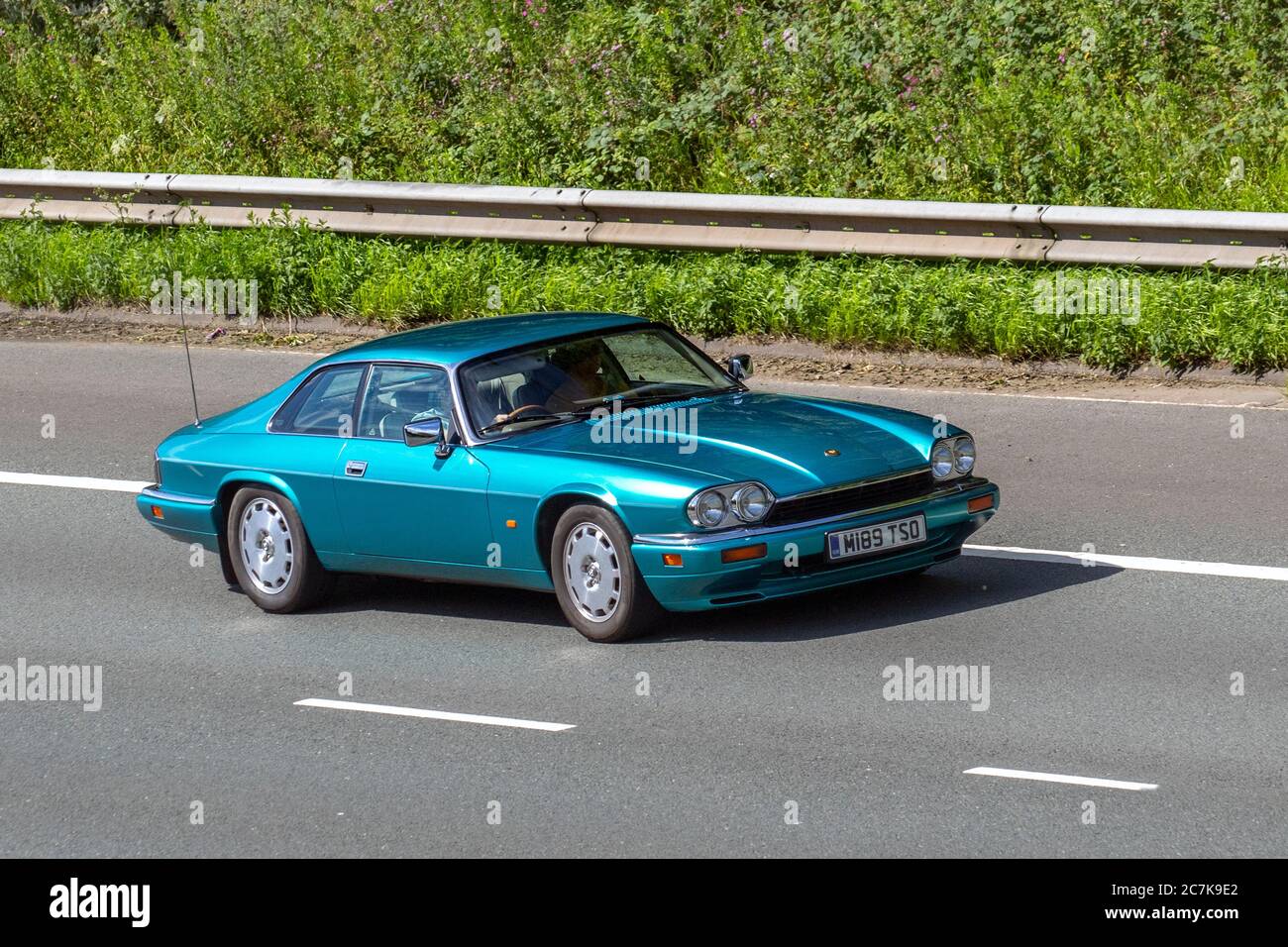 1995 Turquoise Jaguar Xj-S 4.0 Auto; Vehicular traffic moving vehicles, cars driving vehicle on UK roads, 90s motors, motoring on the M6 motorway highway network. Stock Photo