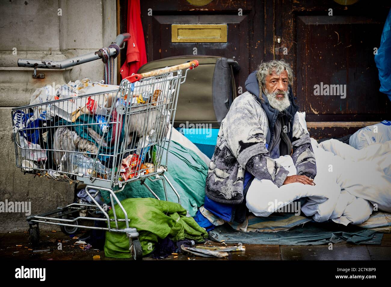 Manchester homeless man sleeping in a doorway near Piccadilly Gardens Stock Photo