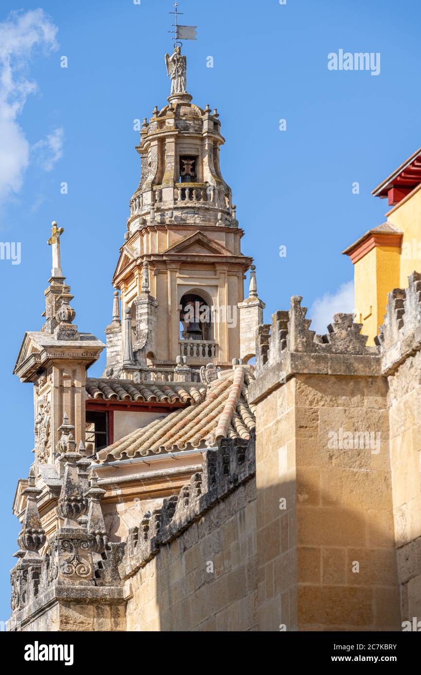 The minaret bell tower, with its statue of Saint Raphael, and the West facade of Cordoba's Mosque-Cathedral. Stock Photo