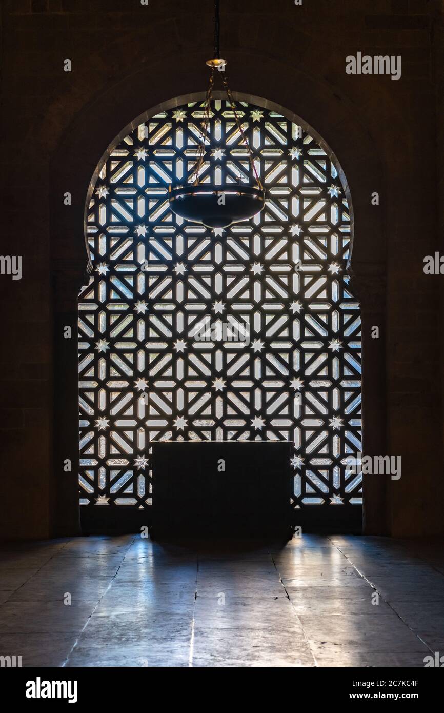 A Lattice window in the Mosque-Cathedral of Cordoba. Made of Canadian cedar it fills a once open arch into the Courtyard of Ablutions from the Mosque Stock Photo