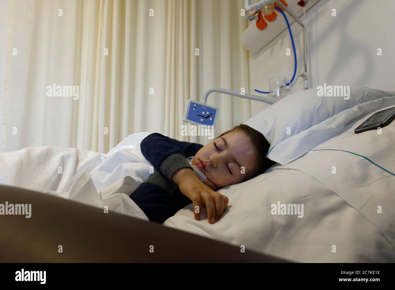 toddler (4 years old) sleeping in a hospital bed Stock Photo