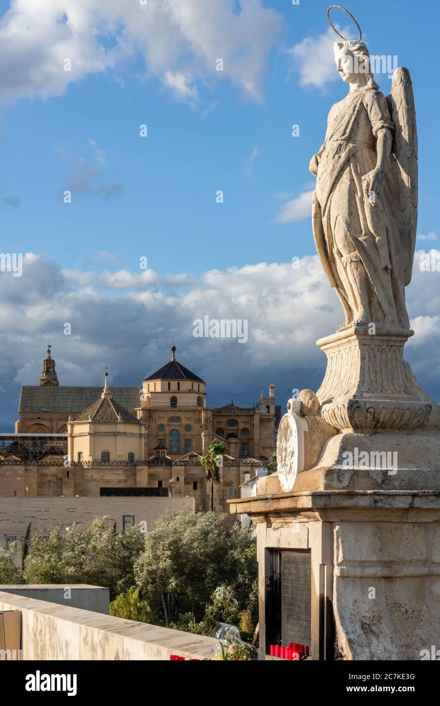 Bernabé Gómez del Río's statue of Archangel San Rafael appears to overlook Cordoba's Mosque-Cathedral from its plinth on the Puente Romano Stock Photo