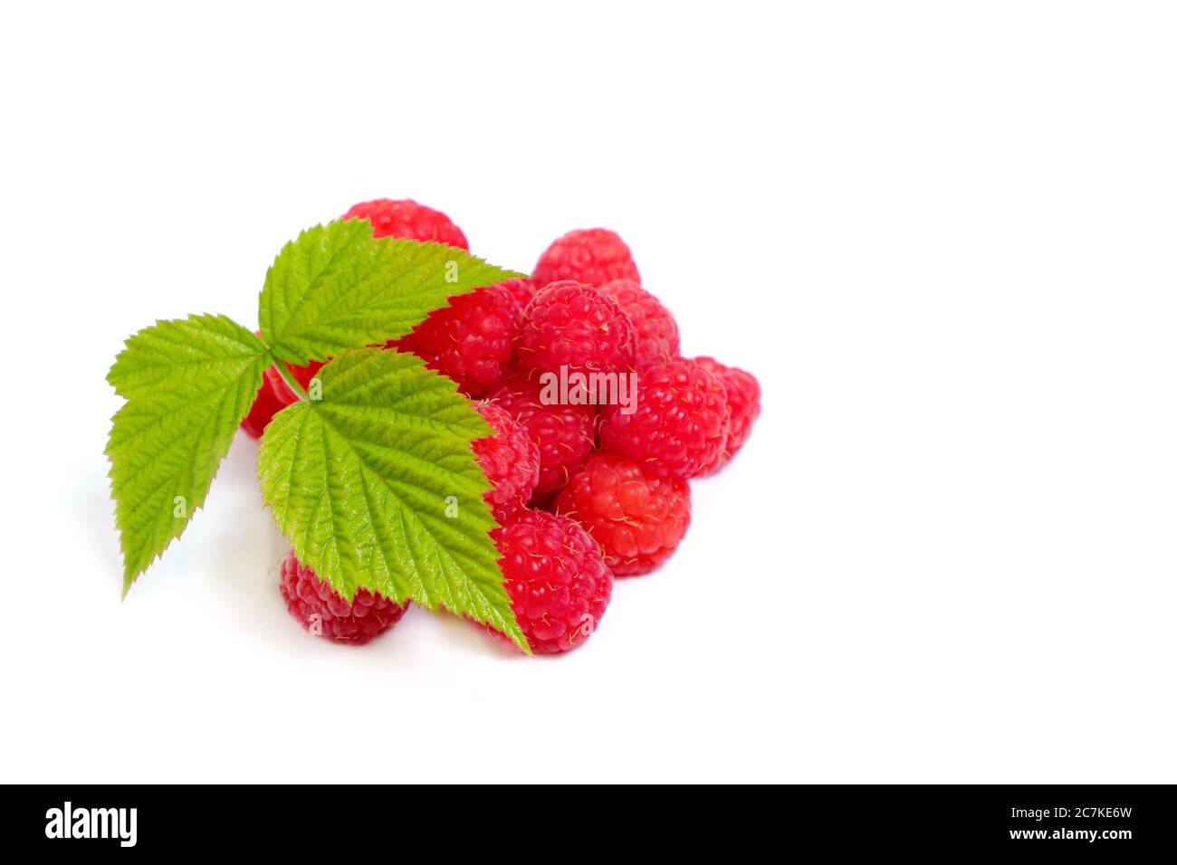 Ripe raspberry berry on a white background with a green leaf Stock Photo